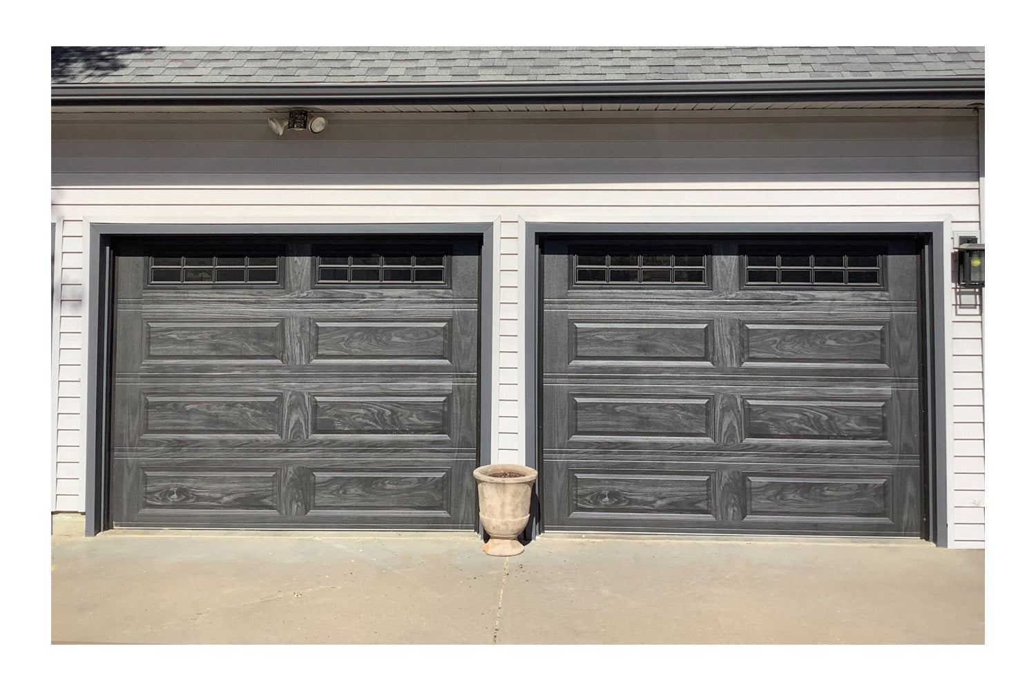 CHI Timeless Raised Panel Insulated Modern Garage Doors with Glass in Woodtone Carbon Oak