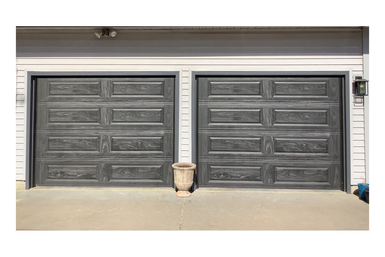 CHI Timeless Raised Panel Insulated Modern Garage Doors in Woodtone Carbon Oak