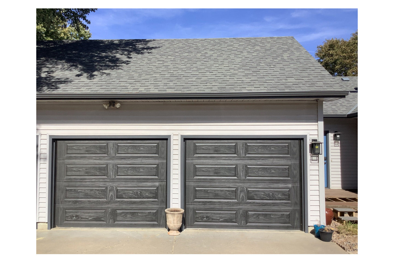 CHI Timeless Raised Panel Insulated Modern Garage Doors in Woodtone Carbon Oak