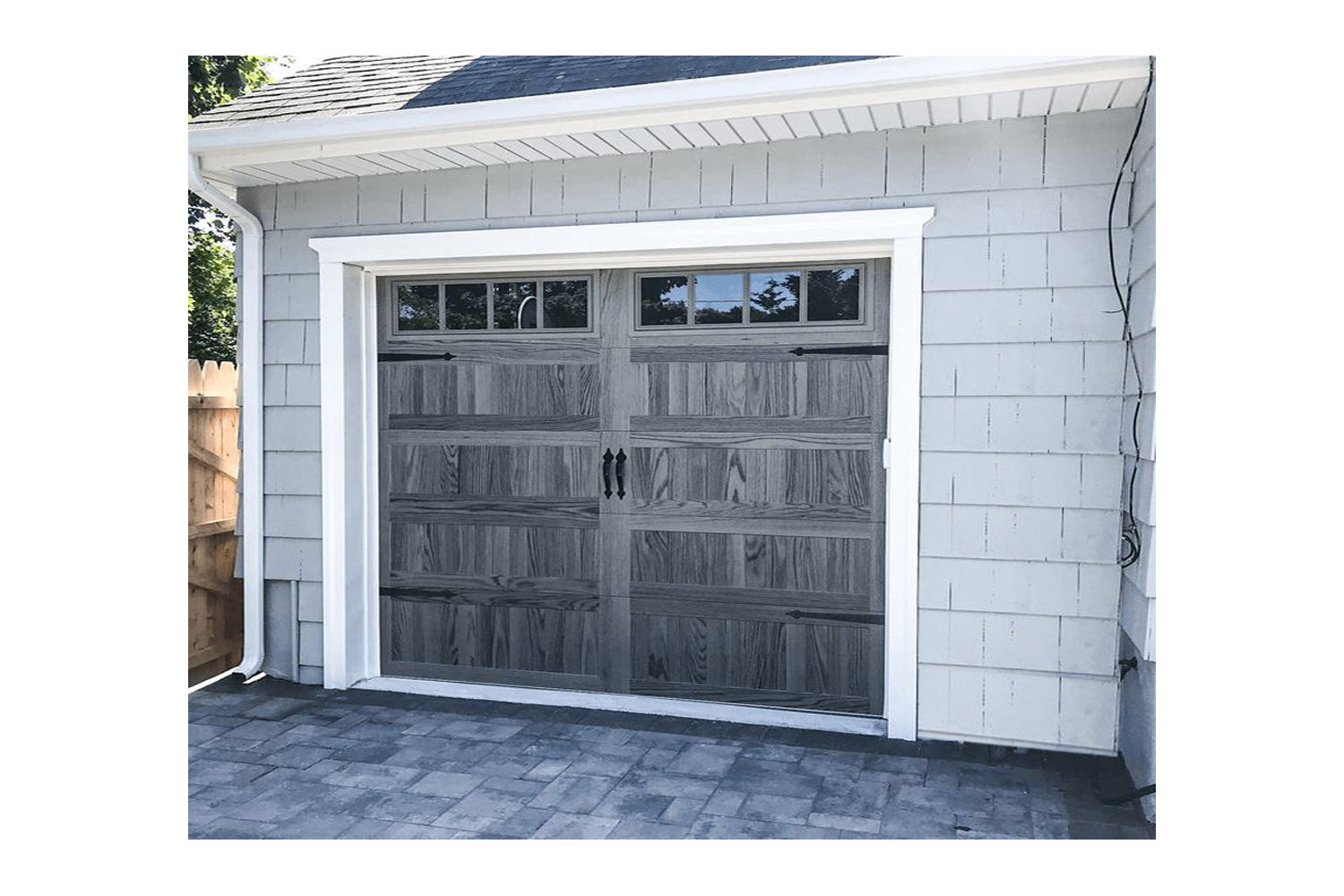 CHI Timeless Stamped Carriage House Insulated Modern Garage Doors with Glass in Woodtone Carbon Oak