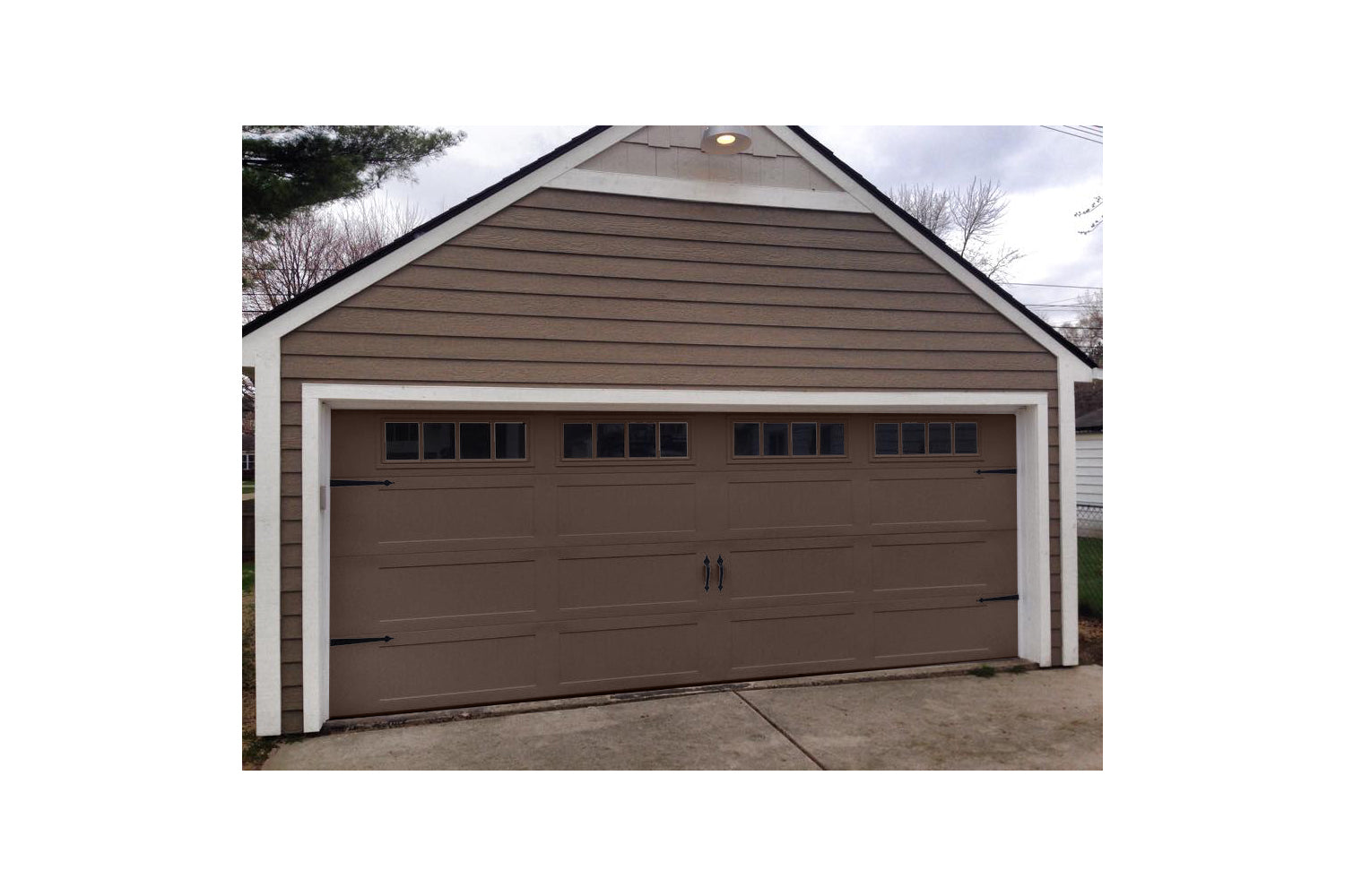 CHI Timeless Stamped Carriage House Insulated Modern Garage Doors in Brown
