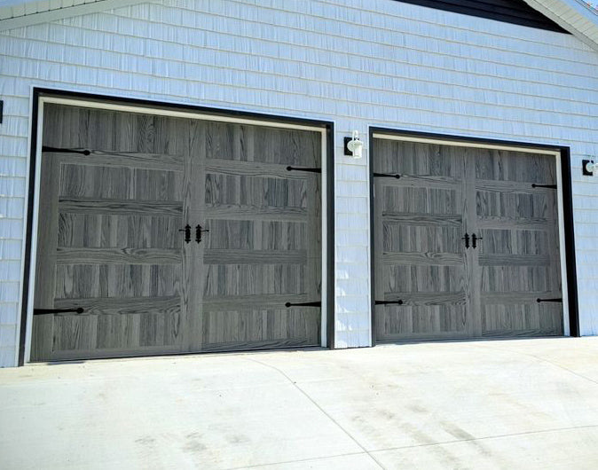 CHI Timeless Stamped Carriage House Insulated Modern Garage Doors in Woodtone Carbon Oak
