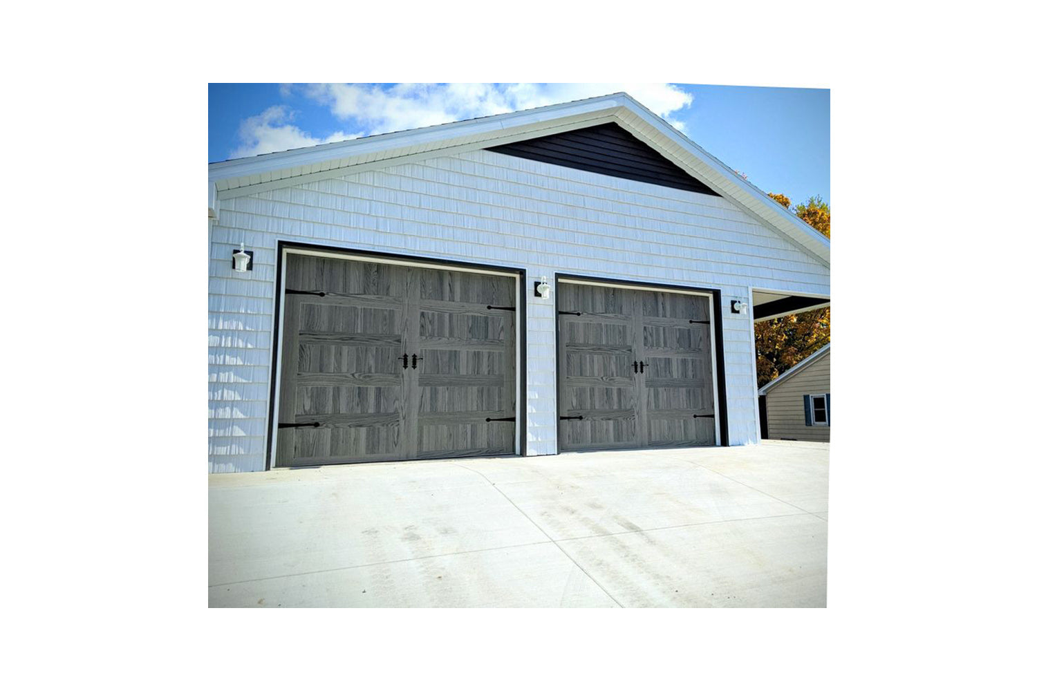 CHI Timeless Stamped Carriage House Insulated Modern Garage Doors in Woodtone Carbon Oak